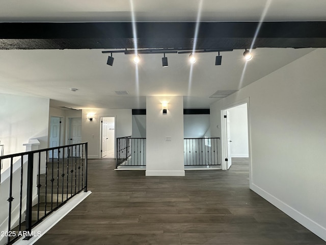 hall featuring dark hardwood / wood-style floors and track lighting