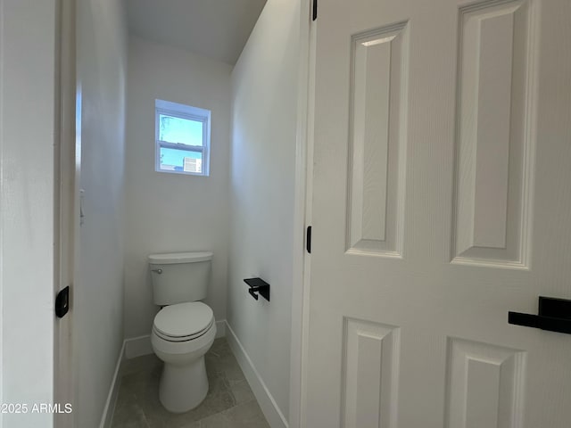 bathroom featuring toilet and tile patterned flooring