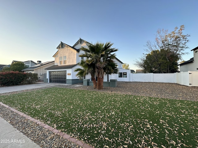 view of front of home with a front yard and a garage