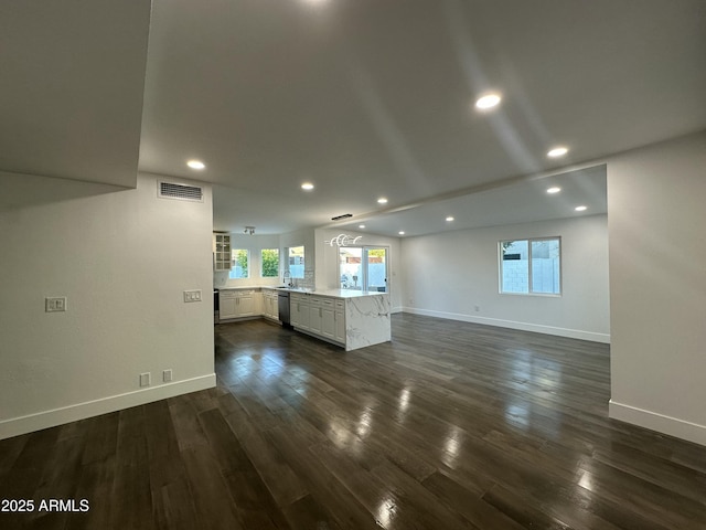 unfurnished living room with dark hardwood / wood-style flooring