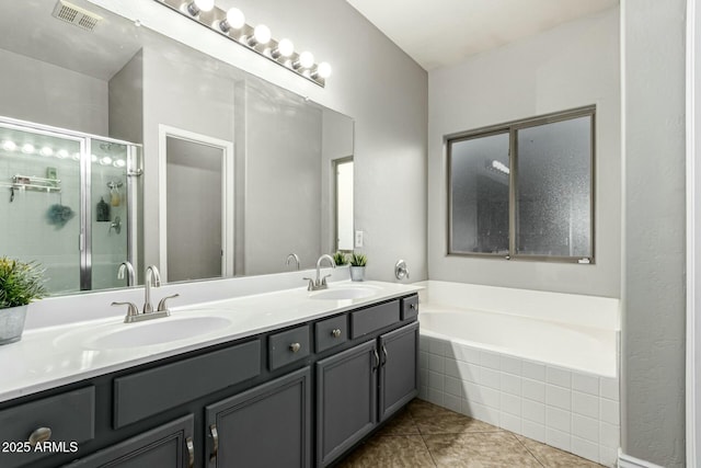 bathroom featuring vanity, shower with separate bathtub, and tile patterned flooring