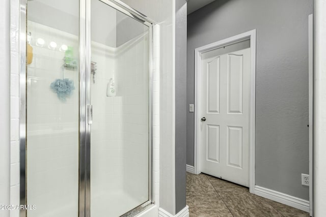 bathroom featuring walk in shower and tile patterned flooring