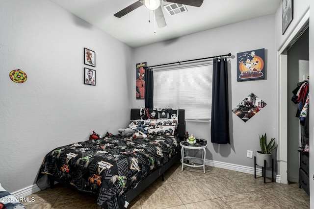 tiled bedroom with ceiling fan