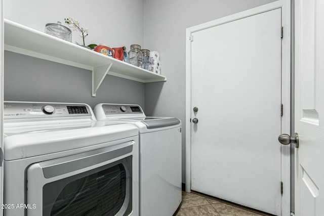 laundry room with washing machine and dryer and light tile patterned flooring