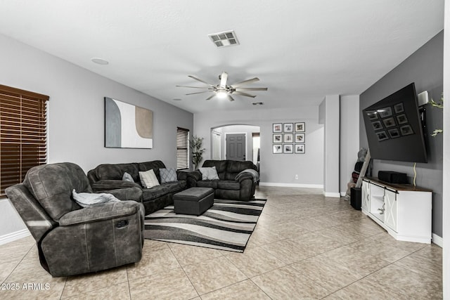 tiled living room with ceiling fan