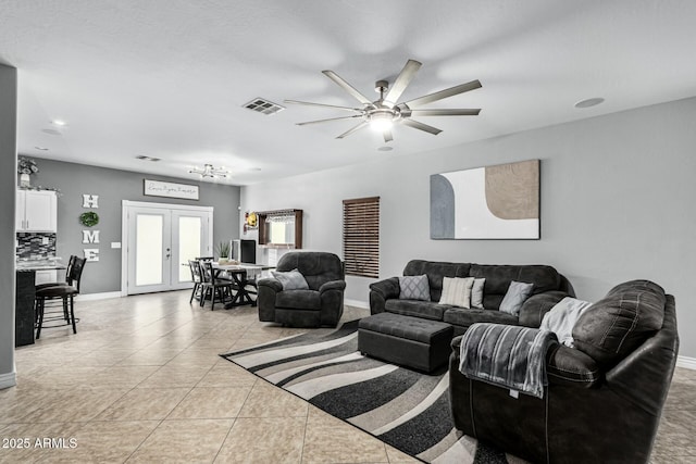 tiled living room with french doors and ceiling fan