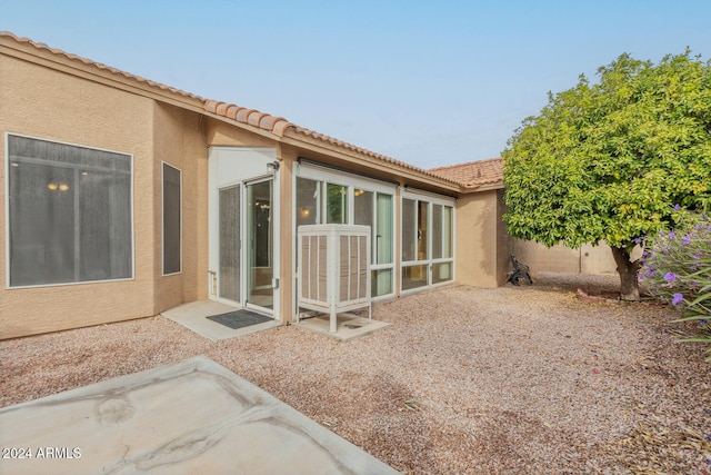 back of house with a patio