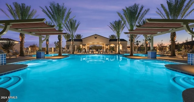 pool at dusk with a patio