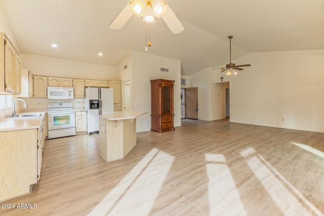 kitchen with sink, high vaulted ceiling, white appliances, a kitchen island, and light wood-type flooring