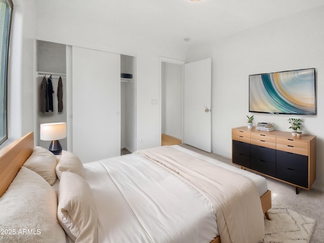 bedroom with light carpet and a closet