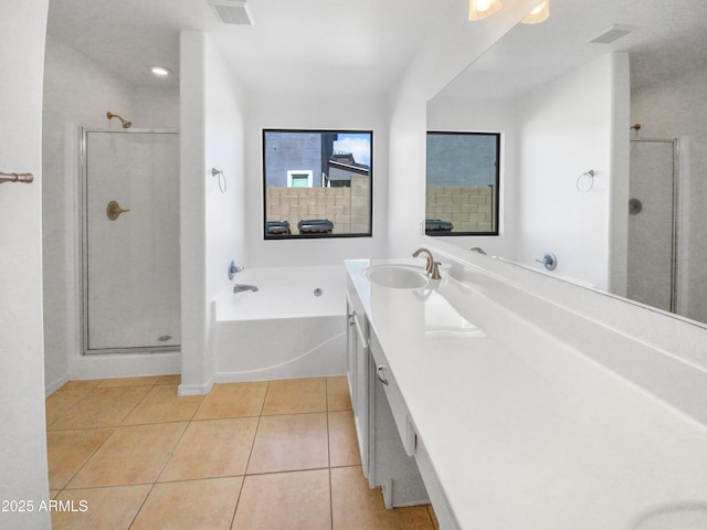 bathroom featuring tile patterned flooring, vanity, and shower with separate bathtub