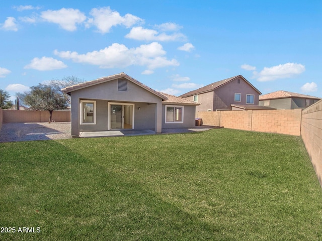 back of property featuring a patio area and a lawn