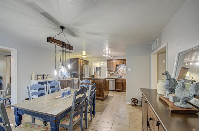 tiled dining space with a textured ceiling