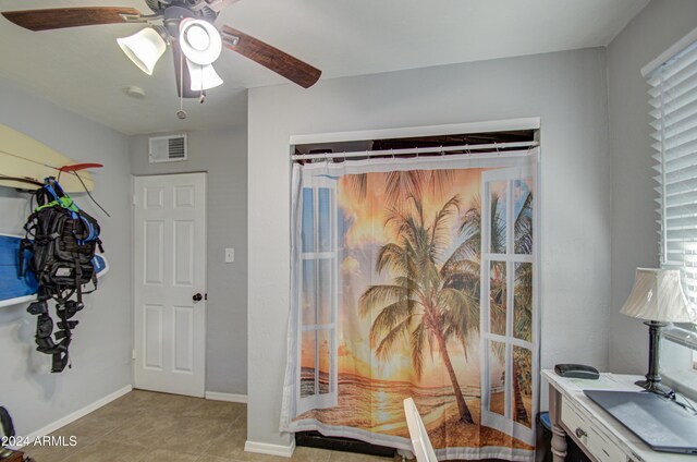 tiled office space with ceiling fan