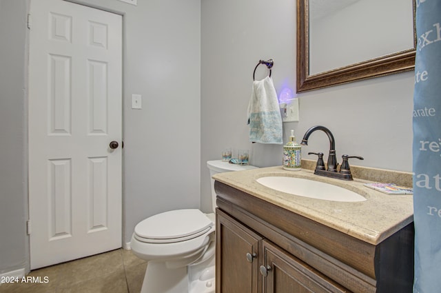 bathroom featuring tile patterned floors, vanity, and toilet