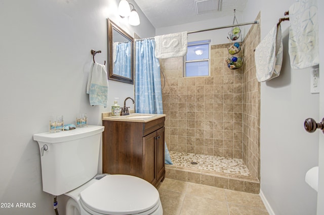 bathroom with curtained shower, tile patterned floors, a textured ceiling, toilet, and vanity