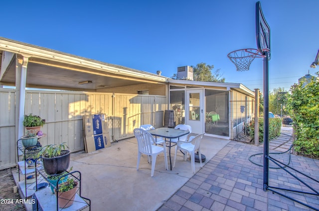 view of patio featuring a sunroom