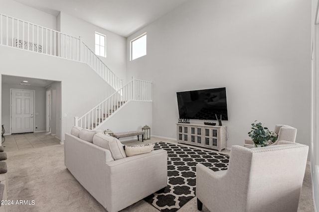 living room with light colored carpet and a high ceiling