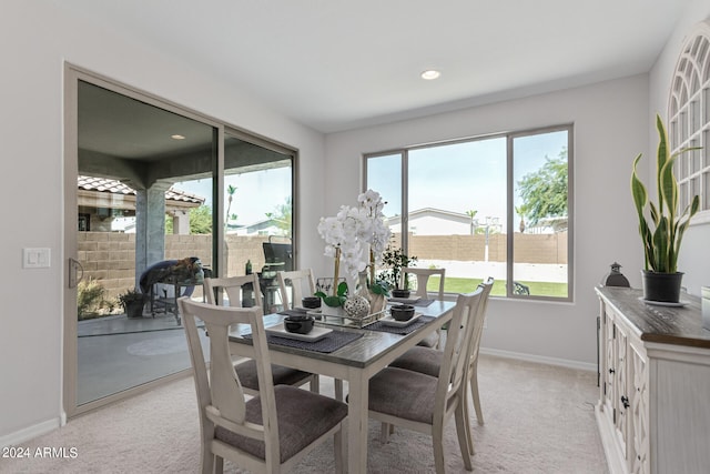 carpeted dining space featuring a wealth of natural light