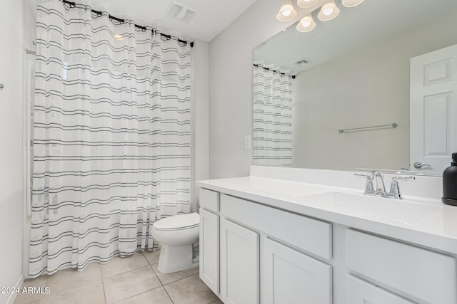 bathroom with a shower with curtain, vanity, tile patterned flooring, and toilet