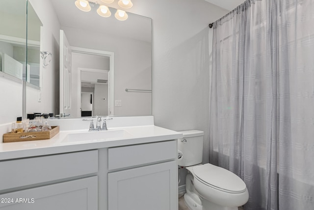 bathroom with vanity, toilet, and a shower with shower curtain