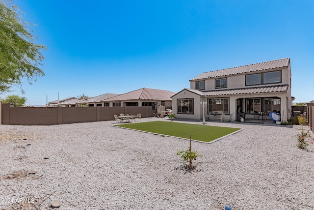 back of house with a patio