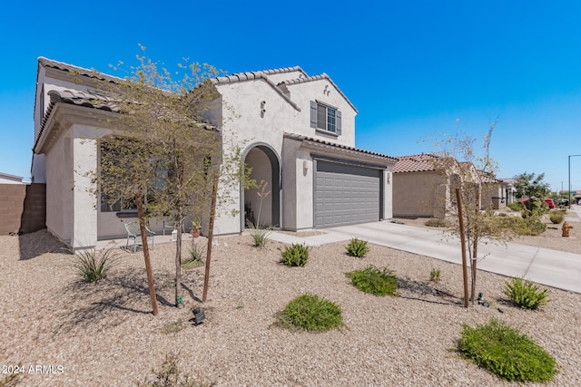 mediterranean / spanish-style home with a garage