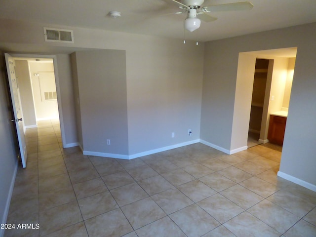 unfurnished room featuring ceiling fan and light tile patterned flooring