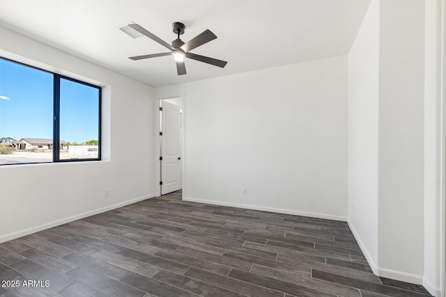 20111 W Saguaro Vista Dr, Wittmann, AZ 85361 - empty room featuring baseboards, ceiling fan, and dark wood-style floors