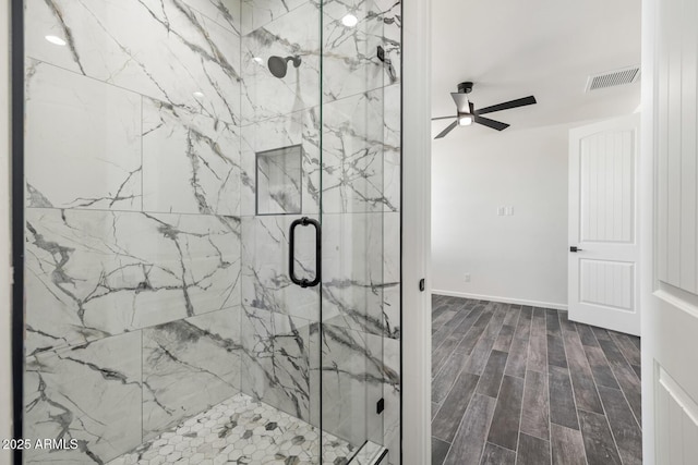 20111 W Saguaro Vista Dr, Wittmann, AZ 85361 - full bathroom with ceiling fan, visible vents, a marble finish shower, and wood finished floors