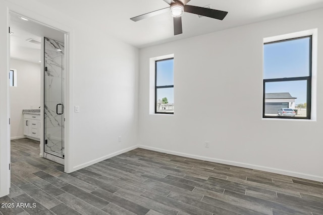 20111 W Saguaro Vista Dr, Wittmann, AZ 85361 - unfurnished bedroom featuring dark wood-style flooring, baseboards, and ceiling fan
