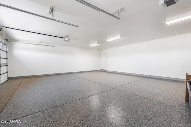 20111 W Saguaro Vista Dr, Wittmann, AZ 85361 - garage featuring baseboards and a garage door opener