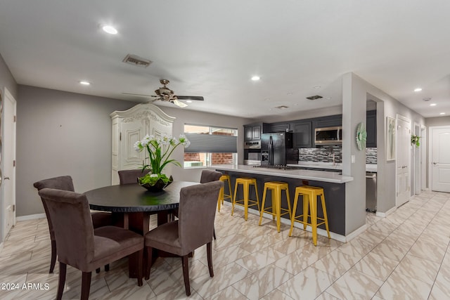 dining room featuring light tile patterned flooring and ceiling fan