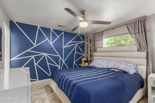 tiled bedroom featuring ceiling fan