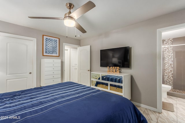 bedroom featuring light tile patterned flooring, a closet, ensuite bathroom, and ceiling fan