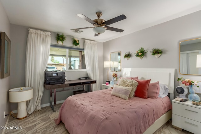 tiled bedroom featuring ceiling fan