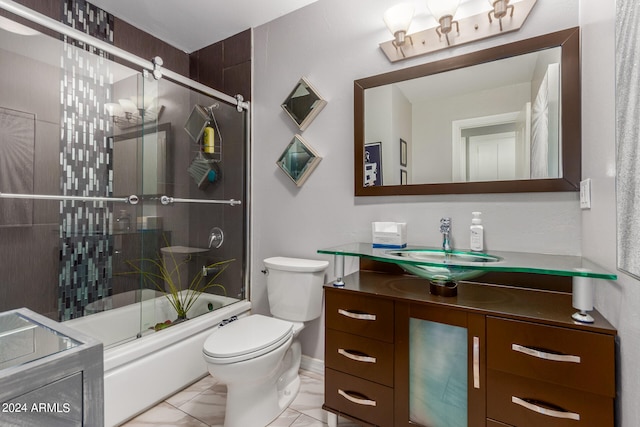 full bathroom with tile patterned floors, vanity, enclosed tub / shower combo, and toilet