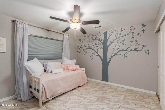 bedroom featuring light tile patterned floors and ceiling fan