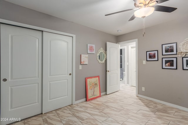 bedroom featuring light tile patterned flooring, a closet, and ceiling fan