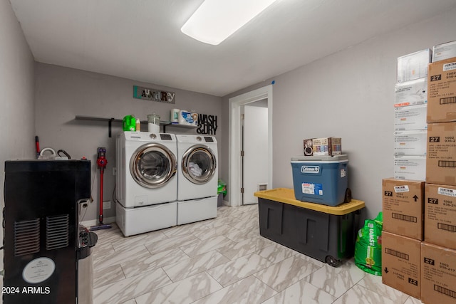 clothes washing area featuring light tile patterned flooring and washing machine and clothes dryer