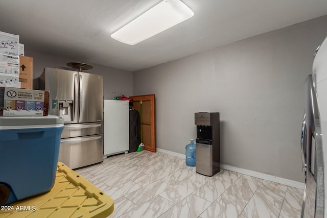 kitchen featuring stainless steel fridge and light tile patterned floors