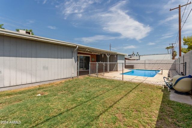 view of yard with a fenced in pool