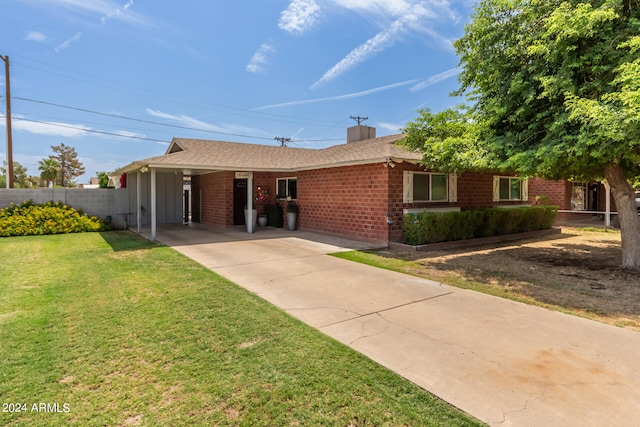 ranch-style house with a carport and a front lawn