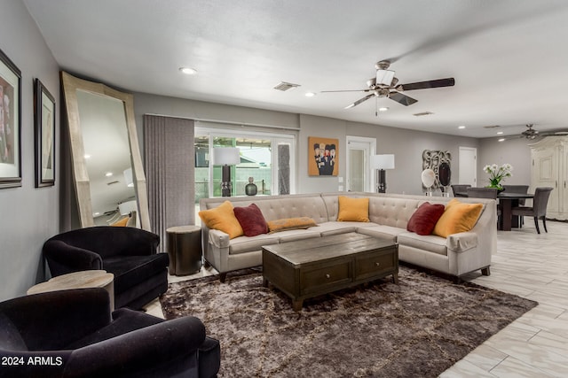 living room with ceiling fan and light tile patterned floors