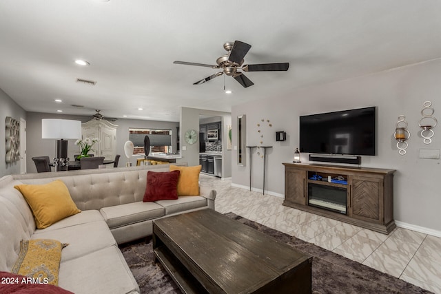 tiled living room with ceiling fan