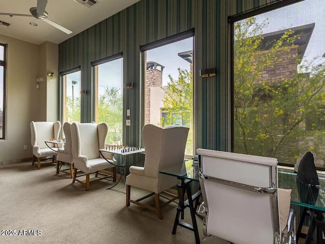 sunroom featuring visible vents and ceiling fan