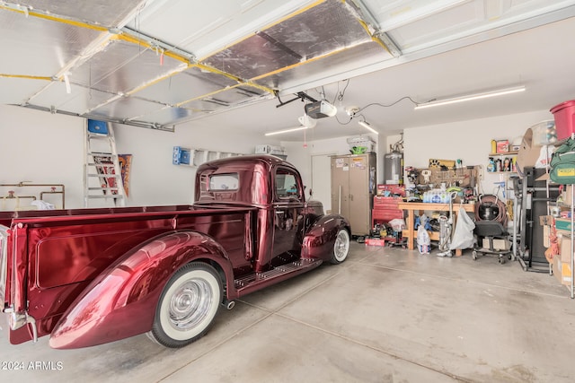 garage with a garage door opener and a workshop area