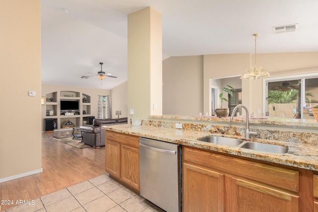 kitchen with ceiling fan with notable chandelier, light tile patterned floors, sink, vaulted ceiling, and stainless steel dishwasher