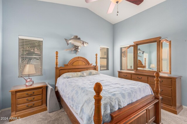 carpeted bedroom with vaulted ceiling and ceiling fan