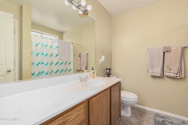 bathroom featuring tile patterned flooring, toilet, and vanity